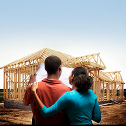 Young couple viewing new construction site